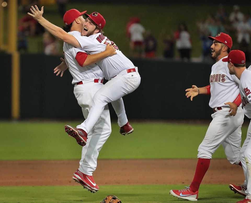 <strong>The Redbirds' Edward Mujica (left) and Jake Woodford celebrate after winning Game 4 of the Pacific Coast League series against Fresno at AutoZone Park on Saturday, Sept. 15. Memphis beat the Grizzlies 5-0 to win their second straight PCL title.</strong> (Jim Weber/Daily Memphian)