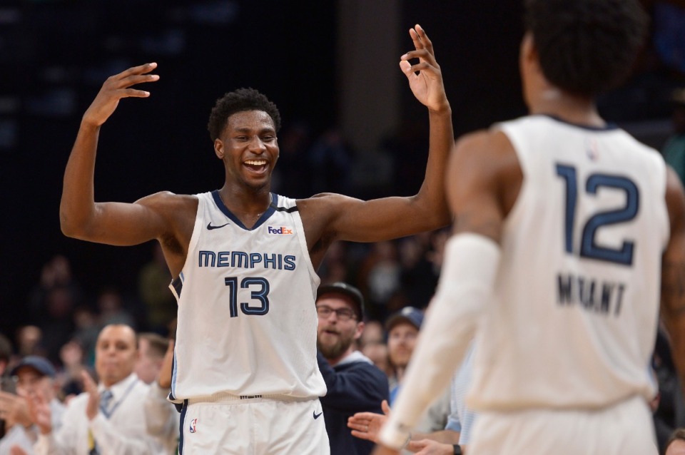 Memphis Grizzlies forward Jaren Jackson Jr. (13) reacts after guard Ja Morant (12) stole the ball in the final seconds of the team's NBA basketball game against the Minnesota Timberwolves on Tuesday, Jan. 7, 2020, in Memphis, Tenn. (AP Photo/Brandon Dill)