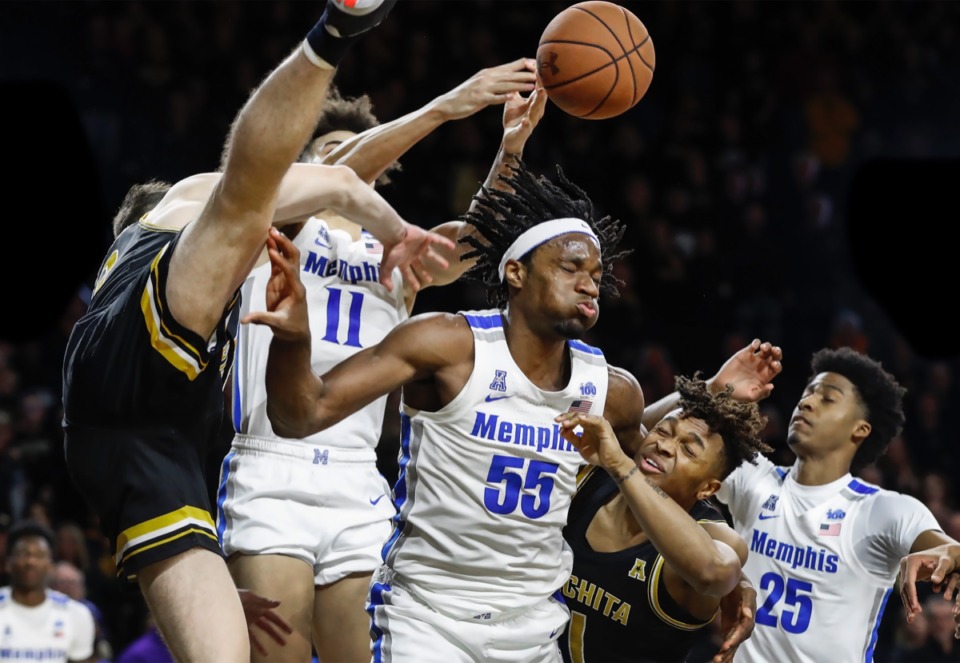 <strong>Memphis forward Precious Achiuwa (middle) battles Wichita State defender Tyson Etienne (middle right) for a rebound as teammate Jayden Hardaway (right) helps on the play Jan. 9, 2020, in Wichita, Kansas.</strong> (Mark Weber/Daily Memphian)