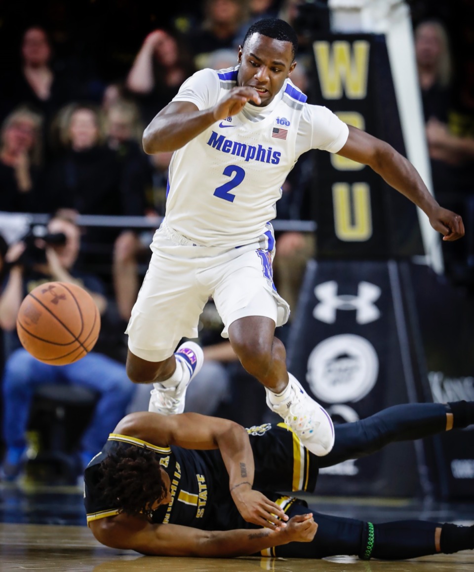 <strong>Memphis defender Alex Lomax (top) leaps over Wichita State guard Tyson Etienne (bottom) while scrambling for a loose ball Jan. 9, 2020, in Wichita, Kansas.</strong> (Mark Weber/Daily Memphian)