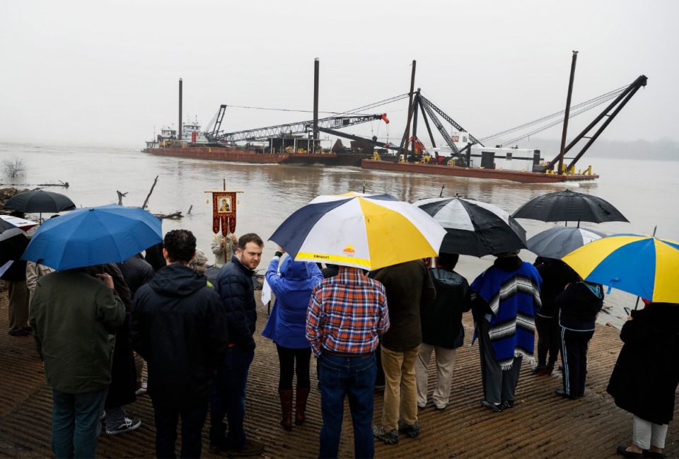 <strong>In heavy fog and a misting rain, a barge rolls up the Mississippi River as a crowd gathers for St. John Orthodox Church's Blessing of the River event on Saturday, Jan. 11, 2020, after severe storms rolled through the Memphis area Saturday morning.</strong> (Mark Weber/Daily Memphian)