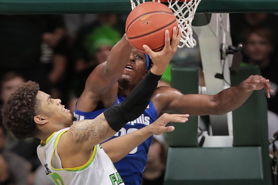 <strong>University of Memphis forward Malcolm Dandridge blocks a shot by the Bulls' David Collins (left) during the Tigers' game on Jan. 12, 2020, against USF at the Yuengling Center.</strong> (Jim Weber/Daily Memphian