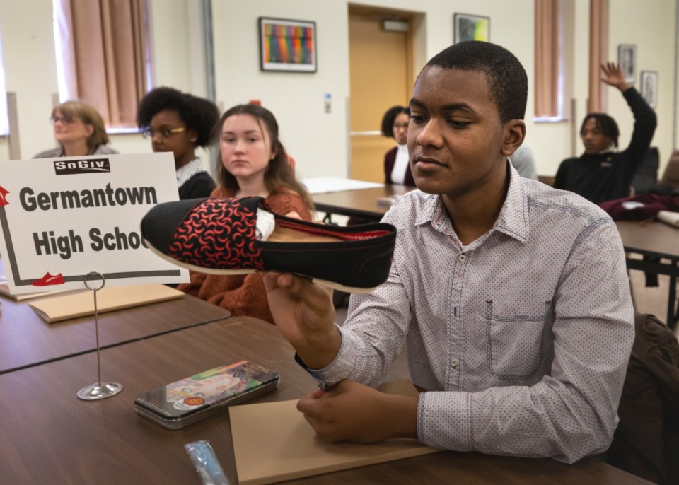 <strong>Germantown High School student Xavier Watson looks at Justin G. Nelson's sickle cell SoGiv shoe design at Shelby County Schools Administration Building on Jan. 13, 2020.</strong> (Ziggy Mack/Special to Daily Memphian)