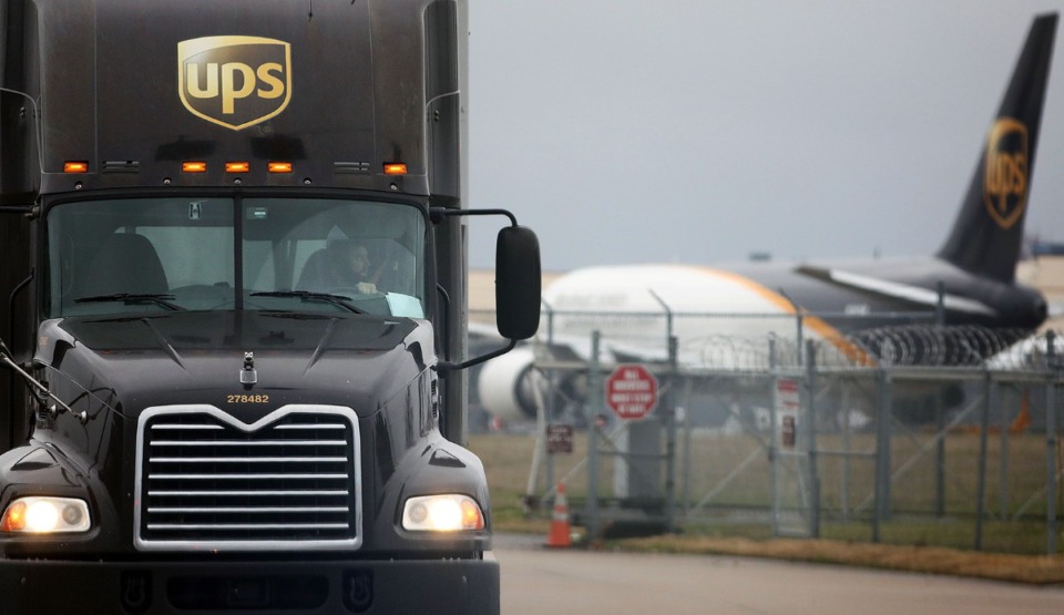 <strong>A UPS driver pulls out of the Atlanta-based shipping company's facility at Memphis International Airport while a cargo plane sits in the background on Jan. 15, 2020.&nbsp;The EDGE board has approved a tax incentive worth $38 million for expansion of UPS&rsquo; air and ground hub at the airport.</strong> (Patrick Lantrip/Daily Memphian)