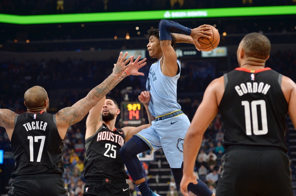 <strong>Memphis Grizzlies guard Ja Morant looks to pass the ball over Houston Rockets forward PJ Tucker (17) and guard Austin Rivers (25) during the second half of an NBA basketball game Tuesday, Jan. 14, 2020, at FedExForum. They are all in his way.</strong> (Brandon Dill/AP)