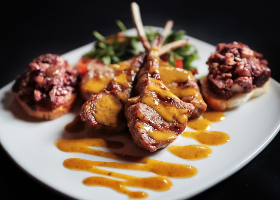 <strong>Grilled lamb lollipops are glazed with rosemary sauce with olive and tomato tapenade on a baguette at Tommy Peters' new Moondance Grill restaurant, which opened last year in Thornwood on Germantown Parkway.</strong> (Jim Weber/Daily Memphian)