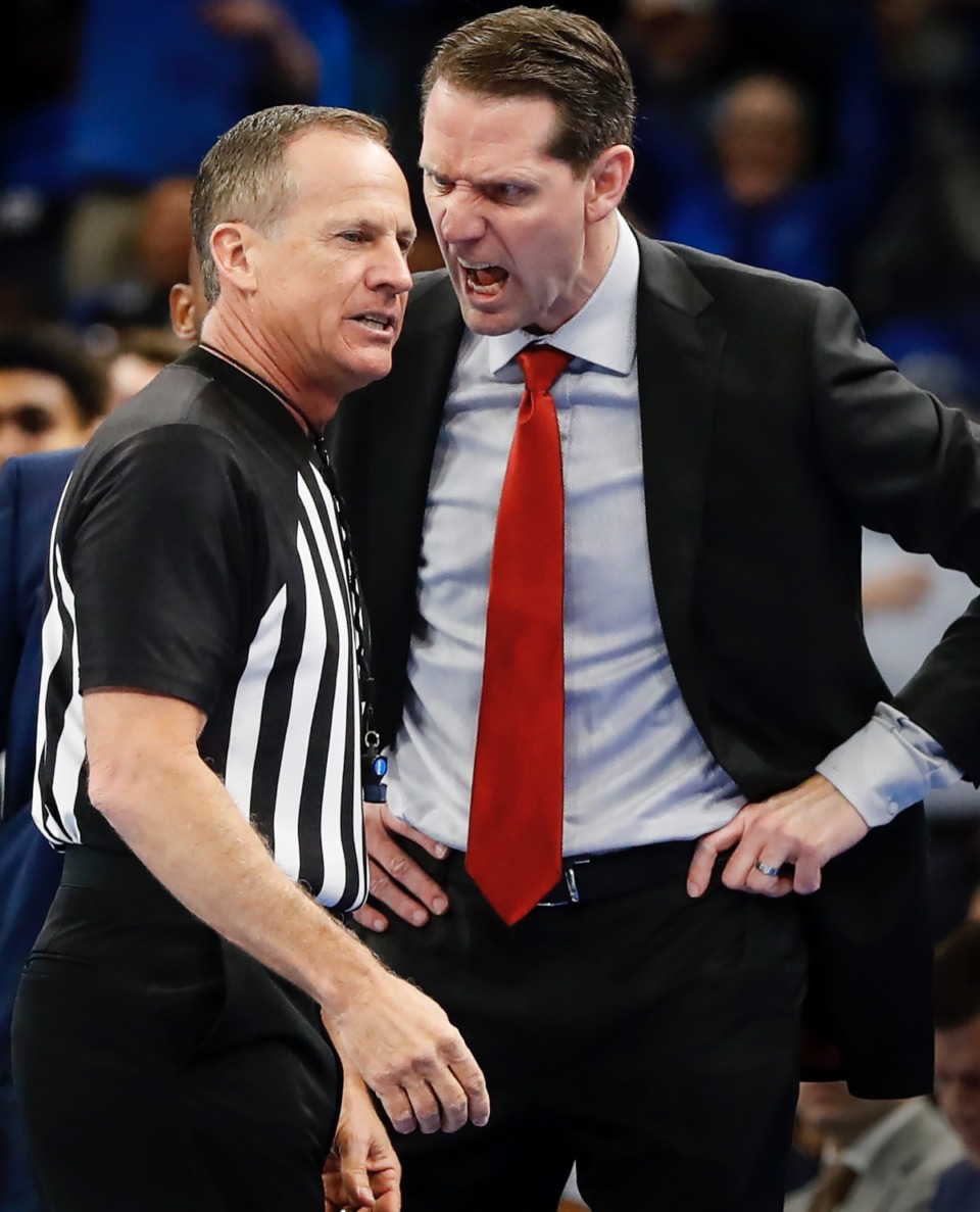 <strong>Cincinnati head coach John Brannen (right) screams at official Terry Oglesby (left) after being called for a technical foul in the game against Memphis Thursday, Jan. 16, 2020, at FedExForum.</strong> (Mark Weber/Daily Memphian)