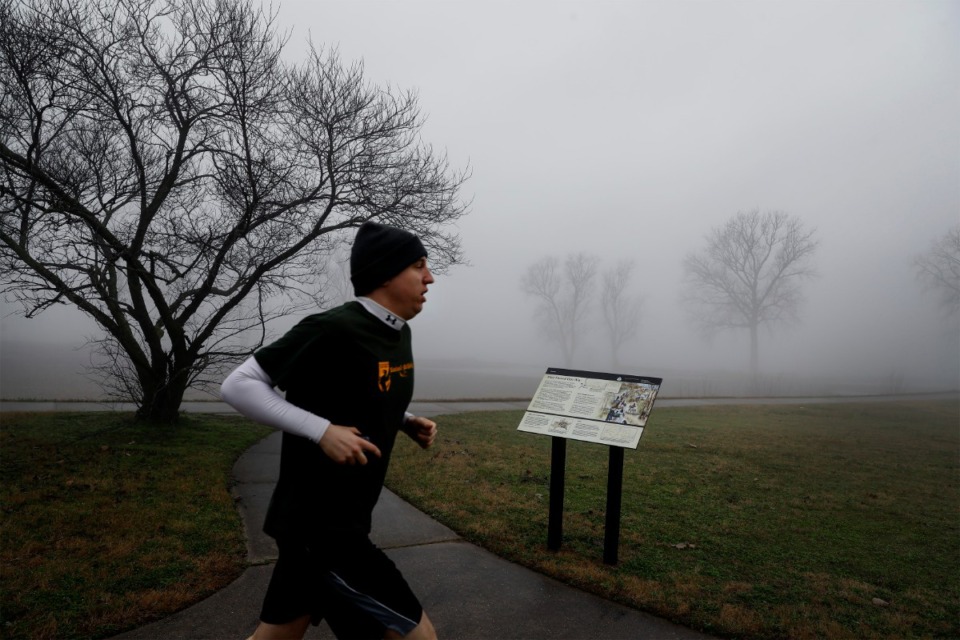<strong>A runner passes a Trail of Tears historical marker in Mud Island&rsquo;s Greenbelt Park on Wednesday, Jan. 15. The marker, dedicated in November, tells the story of how Cherokee people were moved from their homelands after the passing of the Indian Removal Act.</strong> (Mark Weber/Daily Memphian)
