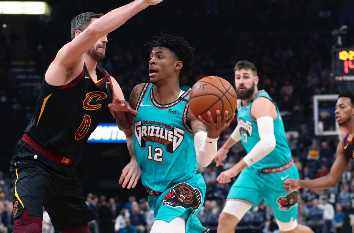 <strong>Memphis Grizzlies guard Ja Morant (12) looks to pass the ball as Cleveland Cavaliers forward Kevin Love (0) defends Friday, Jan. 17, 2020, at FedExForum.</strong> (Karen Pulfer Focht/AP)