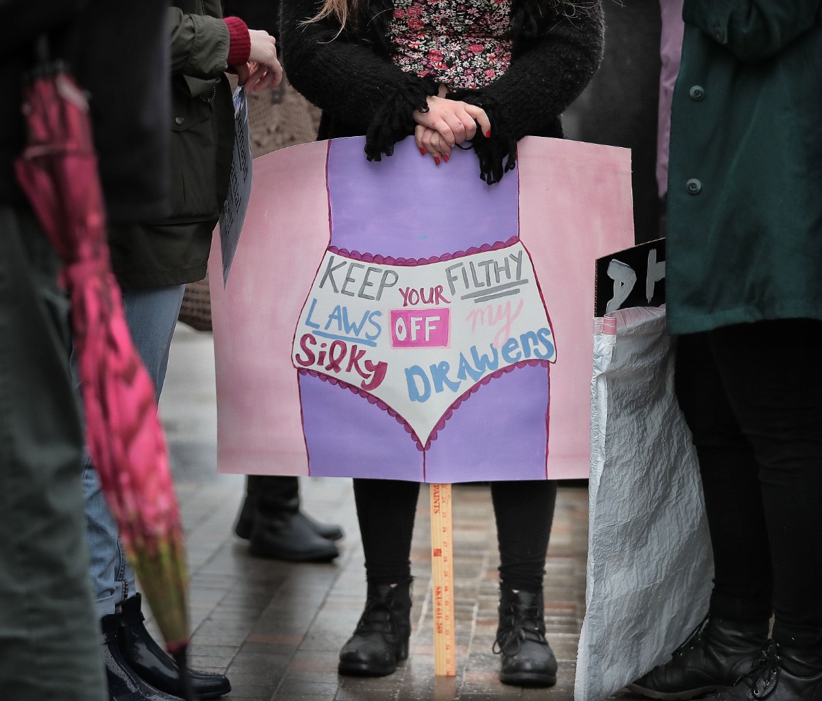 <strong>Madeline Salton waits in the rain at Clayborn Temple before the start of the Memphis Women's March Downtown on Jan. 18, 2020, as over 250 women's rights advocates gathered in the shadow of a looming election year to build awareness for equality, reproductive rights and discrimination issues.</strong> (Jim Weber/Daily Memphian)