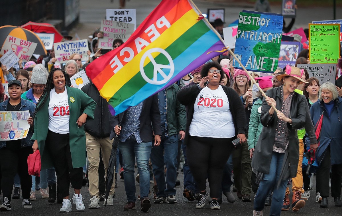 <strong>Event organizer Amber Sherman (center) leads chants for unity during the Memphis Women's March Downtown on Jan. 18, 2020, as over 250 women's rights advocates gathered in the shadow of a looming election year to build awareness for equality, reproductive rights and discrimination issues.</strong> (Jim Weber/Daily Memphian)