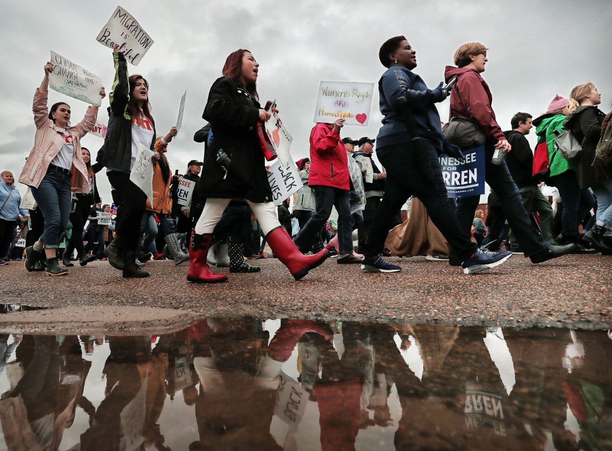 <strong>Marchers brave the rainy weather to attend the Memphis Women's March Downtown on Jan. 18, 2020, as over 250 women's rights advocates gathered in the shadow of a looming election year to build awareness for equality, reproductive rights and discrimination issues.</strong> (Jim Weber/Daily Memphian)