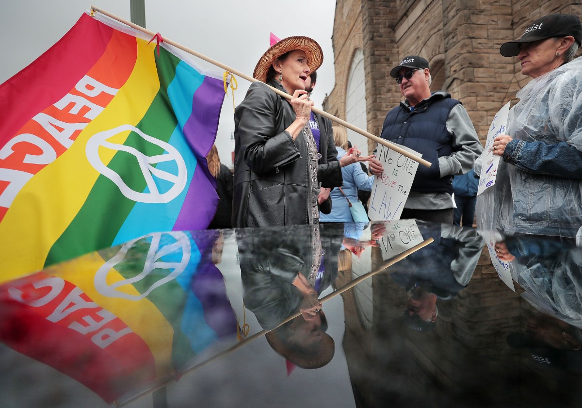 <strong>Patty Crawford (center) talks politics with fellow marchers while waiting in the rain at Clayborn Temple before the start of the Memphis Women's March Downtown on Jan. 18, 2020, as over 250 women's rights advocates gathered in the shadow of a looming election year to build awareness for equality, reproductive rights and discrimination issues.</strong> (Jim Weber/Daily Memphian)