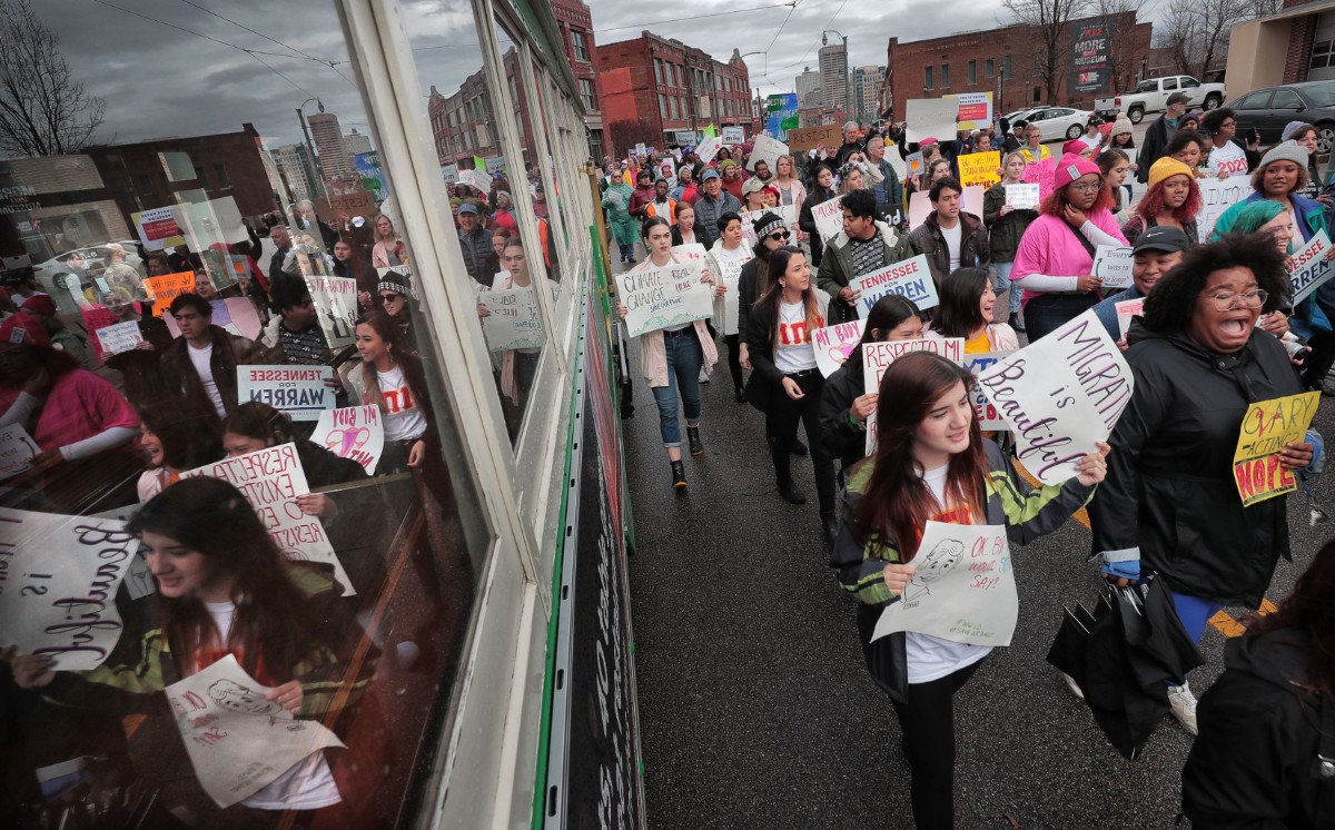 <strong>Marchers pass a trolley on South Main during the Memphis Women's March Downtown on Jan. 18, 2020, as over 250 women's rights advocates gathered in the shadow of a looming election year to build awareness for equality, reproductive rights and discrimination issues.</strong> (Jim Weber/Daily Memphian)