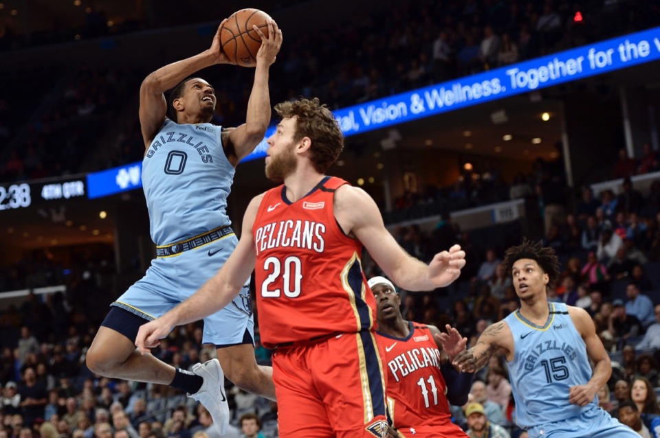 <strong>Memphis Grizzlies guard De'Anthony Melton (0) shoots behind New Orleans Pelicans forward Nicolo Melli (20) as Pelicans guard Jrue Holiday (11) and Grizzlies forward Brandon Clarke (15) move for position</strong>&nbsp;<strong>Jan. 20, 2020,&nbsp;at FedExForum.</strong> (Brandon Dill/AP)