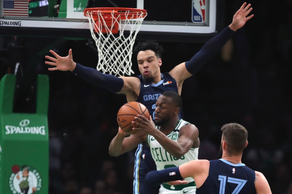 <strong>Memphis Grizzlies guard Dillon Brooks, back, tries to block as Celtics guard Kemba Walker passes the ball &nbsp;Jan. 22, 2020, in Boston.</strong> (AP Photo/Charles Krupa)