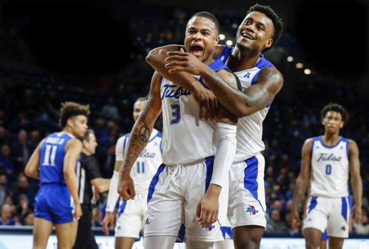 <strong>Tulsa teammates Elijah Joiner (middle) and Martins Igbanu (right) celebrate after a personal foul by Memphis guard Lester Quinones (left) Wednesday, Jan. 22, 2020, in Tulsa, Oklahoma.</strong> (Mark Weber/Daily Memphian)