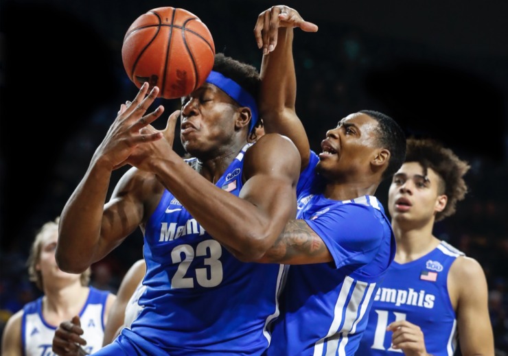 <strong>Memphis forward Malcolm Dandridge (left) loses the ball out of bounds off his head while battling teammate DJ Jeffries (middle) for a rebound as Lester Quinones (right) looks on in the game against the Golden Hurricane Wednesday, Jan. 22, 2020, in Tulsa, Oklahoma.</strong> (Mark Weber/Daily Memphian)