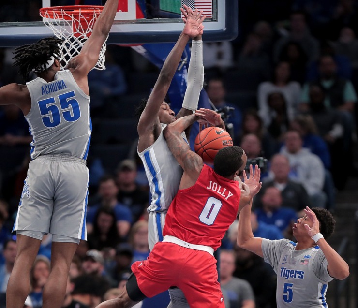 University of Memphis guard Damion Baugh (center) fouls the Mustangs' Tyson Jolly (0) while trying to block a shot during the Tigers' game on Jan. 25, 2020, against SMU at the FedExForum. (Jim Weber/Daily Memphian)