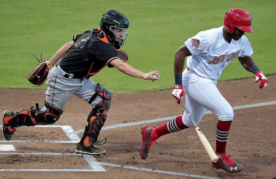 <strong>Grizzlies catcher Garrett Stubbs tries to run down Redbird Justin Williams (right) during Game 4 of the Pacific Coast League series against Fresno at AutoZone Park. Memphis beat the Grizzlies 5-0 to win their second straight PCL title.</strong> (Jim Weber/Daily Memphian)
