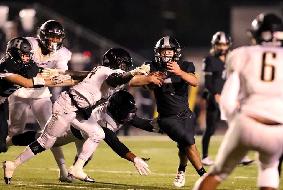 <strong>Houston High running back Lincoln Pare (4) dodges defenders as he runs upfield against Whitehaven High Friday, Nov. 9. The game was the first playoff matchup between the two schools since 2000.</strong>&nbsp;(Houston Cofield/Daily Memphian)