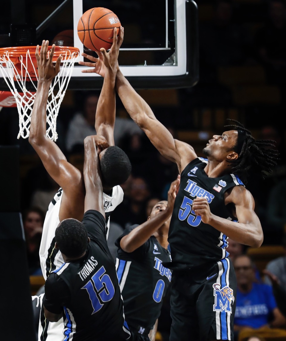 <strong>Memphis defender Precious Achiuwa (right) blocks the shot of UCF forward Collin Smith (middle) as teammate Lance Thomas (bottom) helps defend on the play during action on Wednesday, Jan. 29, 2020, in Orlando.</strong> (Mark Weber/Daily Memphian)