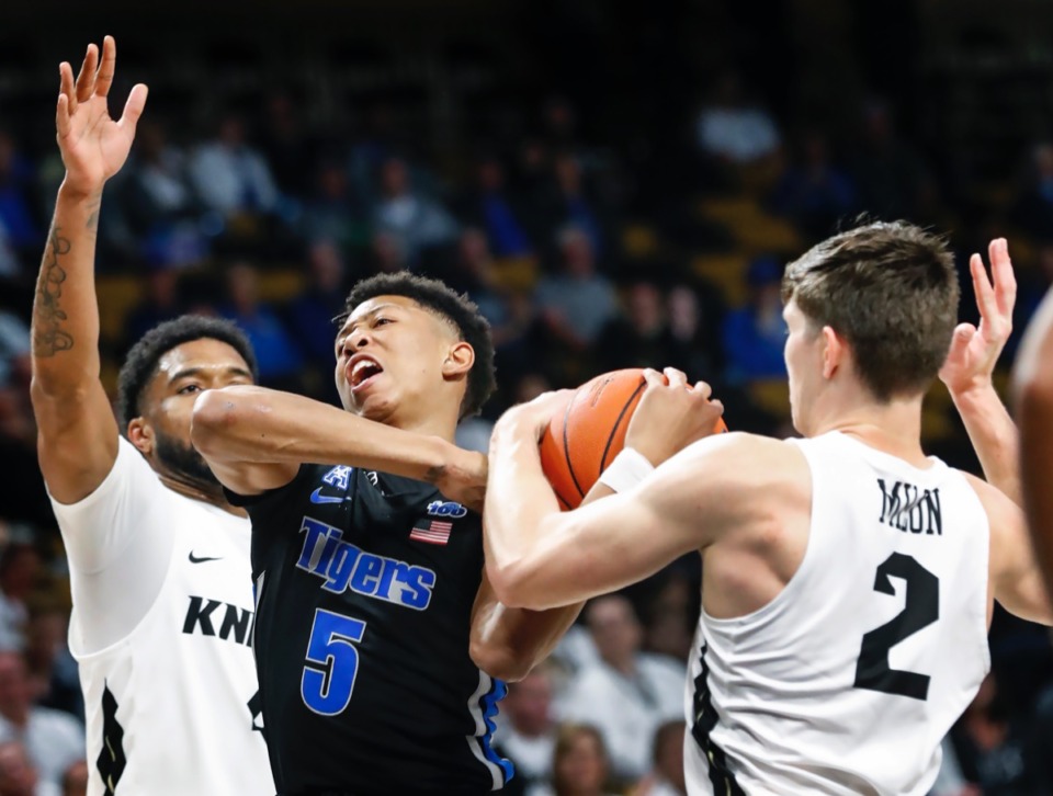 <strong>Memphis guard Boogie Ellis (middle) loses control of the ball while driving the lane against UCF defenders Ceasar DeJesus (left) and Matt Milon (right) during action on Wednesday, Jan. 29, 2020, in Orlando.</strong> (Mark Weber/Daily Memphian)
