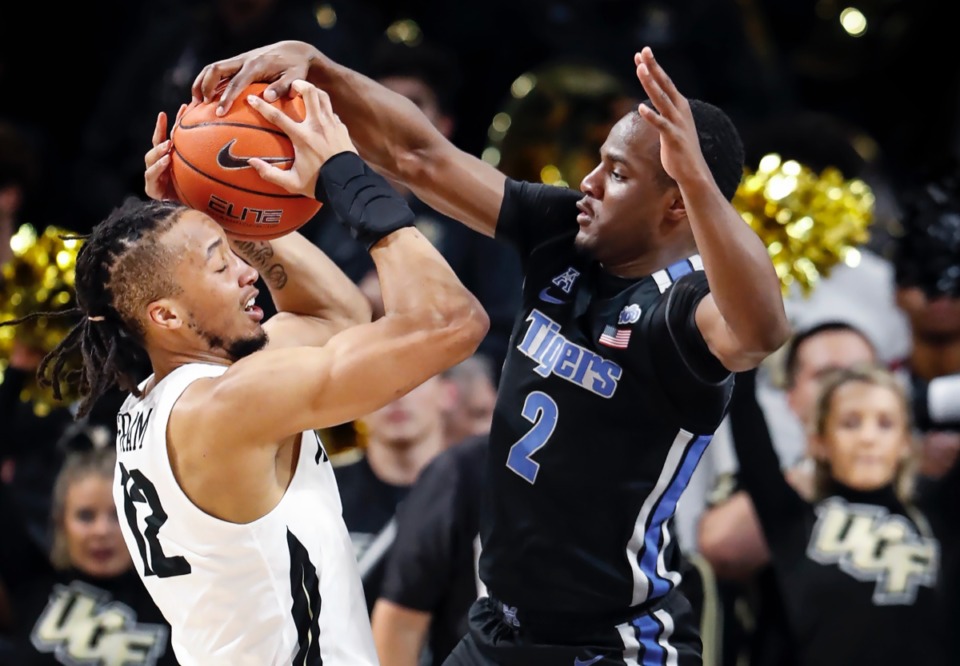 <strong>Memphis defender Alex Lomax (right) applies pressure to UCF guard Dazon Ingram (left) during action on Wednesday, Jan. 29, 2020, in Orlando.</strong> (Mark Weber/Daily Memphian)