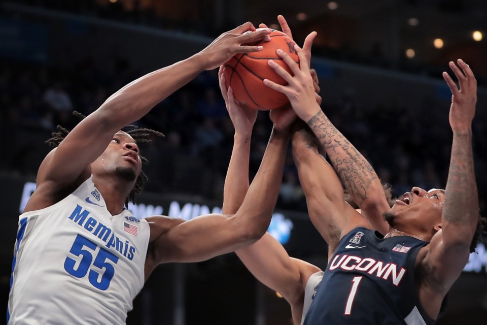 <p class="p1"><span class="s1"><strong>University of Memphis guard Jayden Hardaway (25) scrambles for a loose ball under pressure by the Huskies' Brendan Adams (left) and Isaiah Whley (right) during the Tigers' game on Feb. 1, 2020, against Connecticut at FedExForum in Memphis. </strong>(Jim Weber/Daily Memphian)</span>