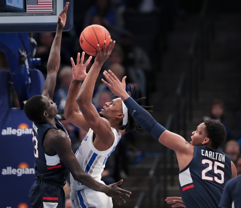 <p class="p1"><span class="s1"><strong>University of Memphis forward Precious Achiuwa (55) shoots under pressure by the Huskies Akok Akok (left) and Josh Carlton (25) during the Tigers' game on Feb. 1, 2020, against Connecticut at FedExForum in Memphis.</strong> (Jim Weber/Daily Memphian)</span>