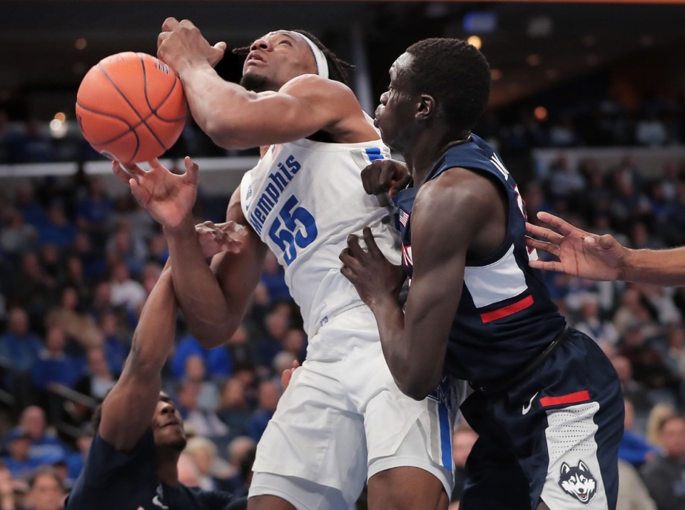 <strong>University of Memphis forward Precious Achiuwa (55) shoots under pressure by the Huskies' Akok Akok (right) and Alterique Gilbert (left) during the Tigers' game on Feb. 1, 2020, against Connecticut at FedExForum in Memphis.</strong> (Jim Weber/Daily Memphian)