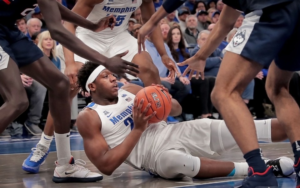 <strong>University of Memphis forward Malcolm Dandridge (center) looks for an open man after picking up a loose ball during the Tigers' game on Feb. 1, 2020, against Connecticut at FedExForum in Memphis.</strong> (Jim Weber/Daily Memphian)