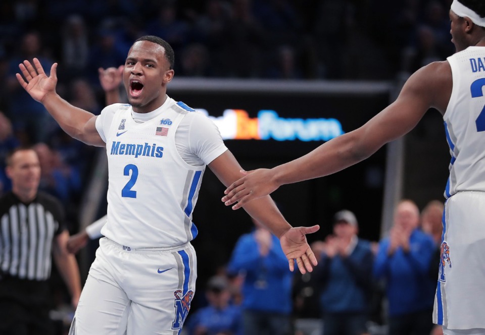 <strong>University of Memphis guard Alex Lomax (2) celebrates with Malcolm Dandridge (right) after a scoring drive during the Tigers' game on Feb. 1, 2020, against Connecticut at FedExForum in Memphis.</strong> (Jim Weber/Daily Memphian)