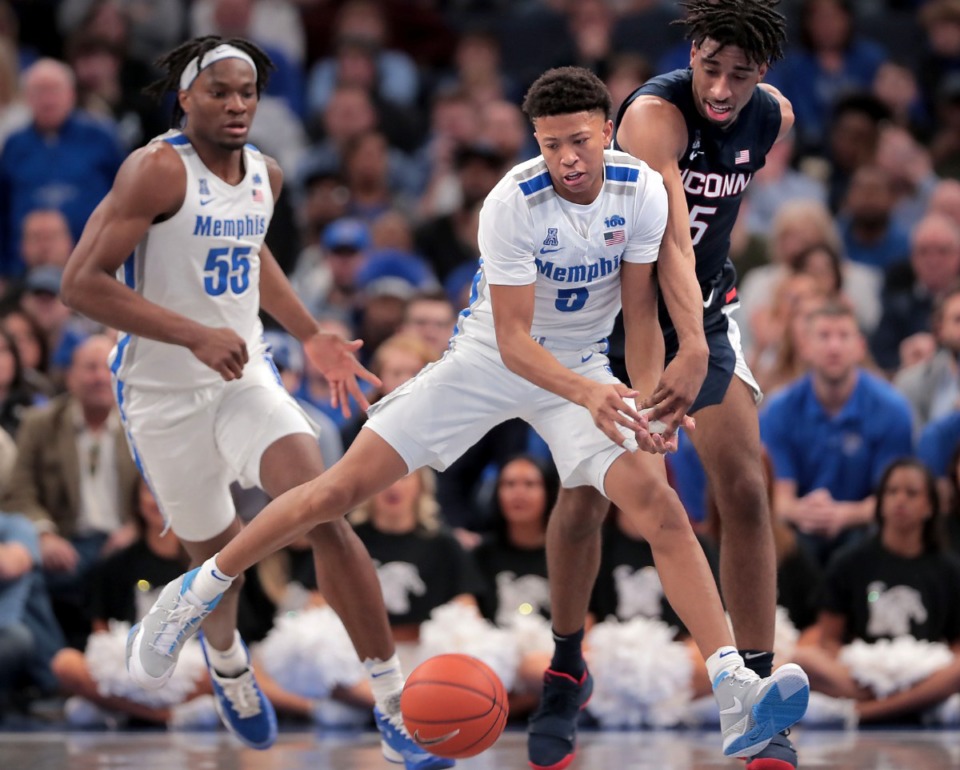 <strong>University of Memphis guard Boogie Ellis (5) and Precious Achiuwa (55) lose control of the ball under pressure by the Huskies' Isaiah Whaley (right) during the Tigers' game on Feb. 1, 2020, against Connecticut at FedExForum in Memphis.</strong> (Jim Weber/Daily Memphian)