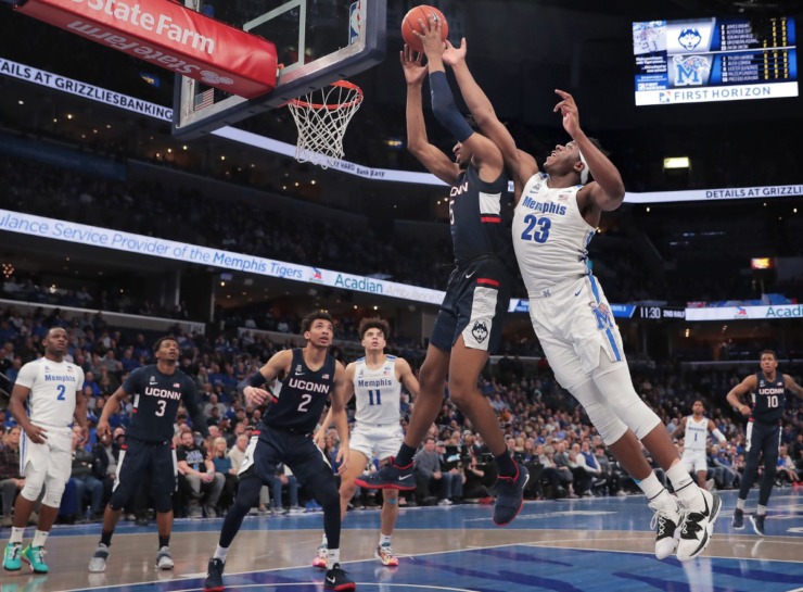 <strong>University of Memphis forward Malcolm Dandridge (23) battles for a rebound with the Huskies' Isaiah Whaley (5) during the Tigers' game on Feb. 1, 2020, against Connecticut at FedExForum in Memphis.</strong> (Jim Weber/Daily Memphian)