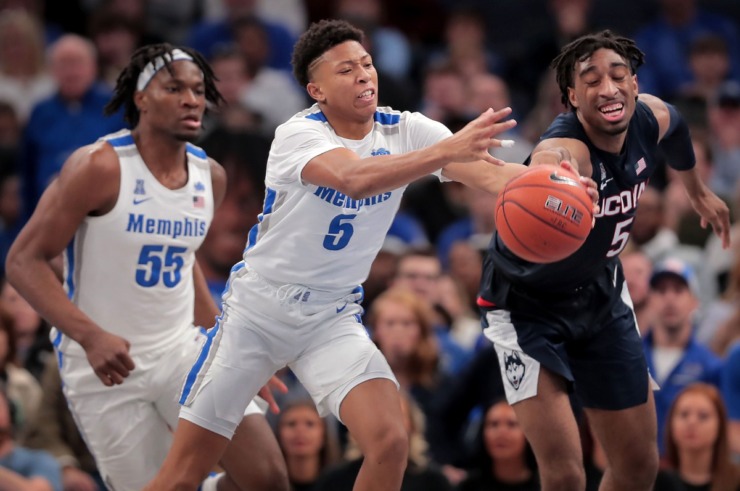 <strong>University of Memphis guard Boogie Ellis (5) stretches for a loose ball under pressure by the Huskies' Isaiah Whaley (right) during the Tigers' game on Feb. 1, 2020, against Connecticut at FedExForum in Memphis.</strong> (Jim Weber/Daily Memphian)