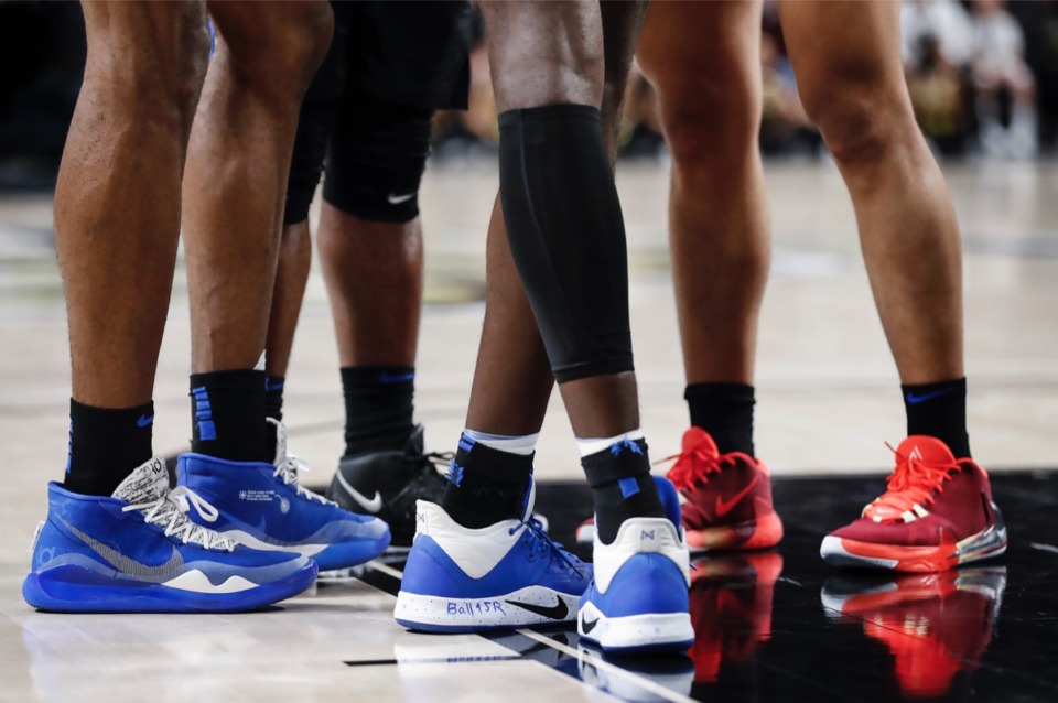 <strong>Memphis forward Lance Thomas (middle) writes LLJR in his shoes to honor a late cousin.</strong> (Mark Weber/Daily Memphian)