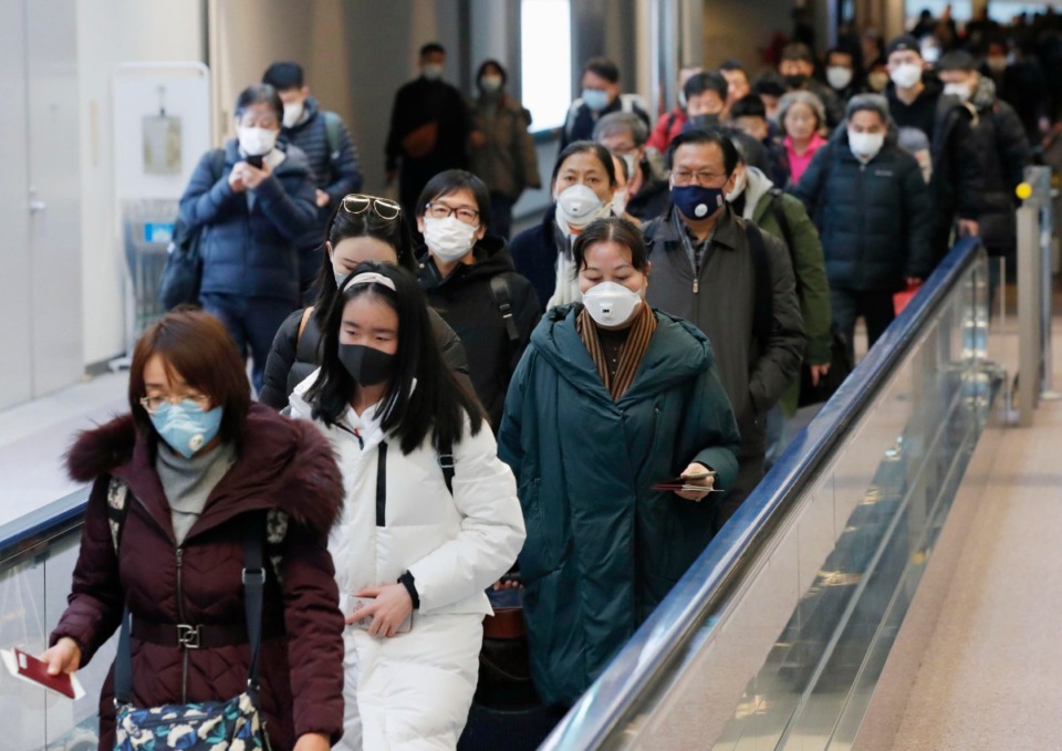 <strong>Passengers who flew from the Chinese city of Wuhan, the epicenter of a pneumonia-causing new coronavirus, arrive at Narita airport near Tokyo on Jan. 23, 2020.</strong> (Kyodo via AP Images)&nbsp;