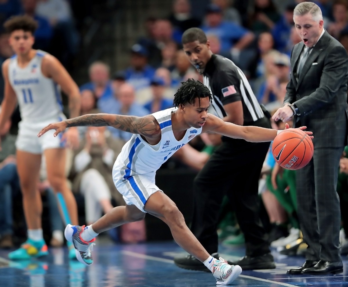 <strong>University of Memphis guard Tyler Harris stretches to pull a loose ball inbound during the Tigers' game on Feb. 8, 2020, against USF at FedExForum in Memphis.</strong> (Jim Weber/Daily Memphian)