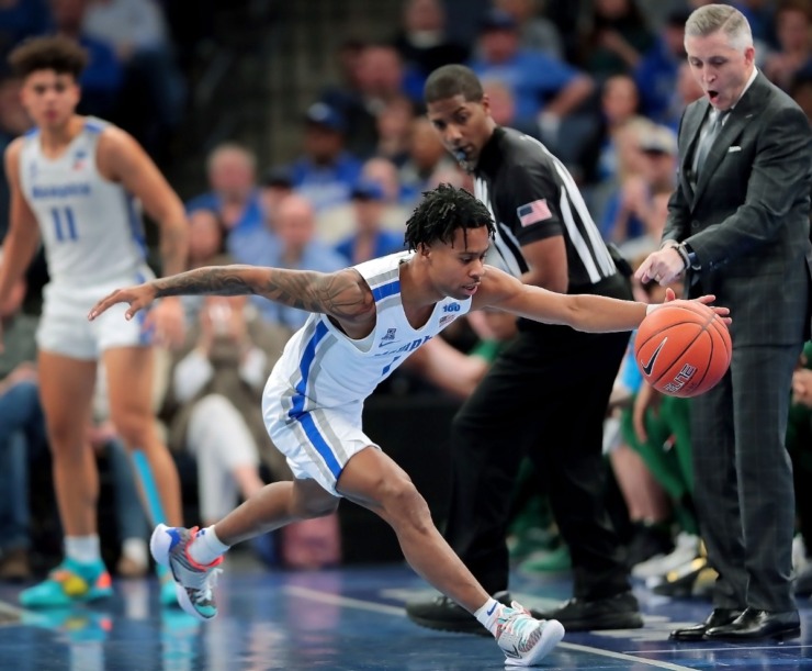 <strong>University of Memphis guard Tyler Harris stretches to pull a loose ball inbounds during the Tigers' game on Feb. 8, 2020, against USF at FedExForum in Memphis.</strong> (Jim Weber/Daily Memphian)