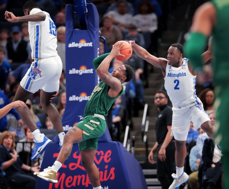 <strong>Bulls guard Laquincy Rideau shoots under pressure by University of Memphis guard Alex Lomax (2) and Lance Thomas (15) during the Tigers' game on Feb. 8, 2020, against USF at FedExForum in Memphis.</strong> (Jim Weber/Daily Memphian)