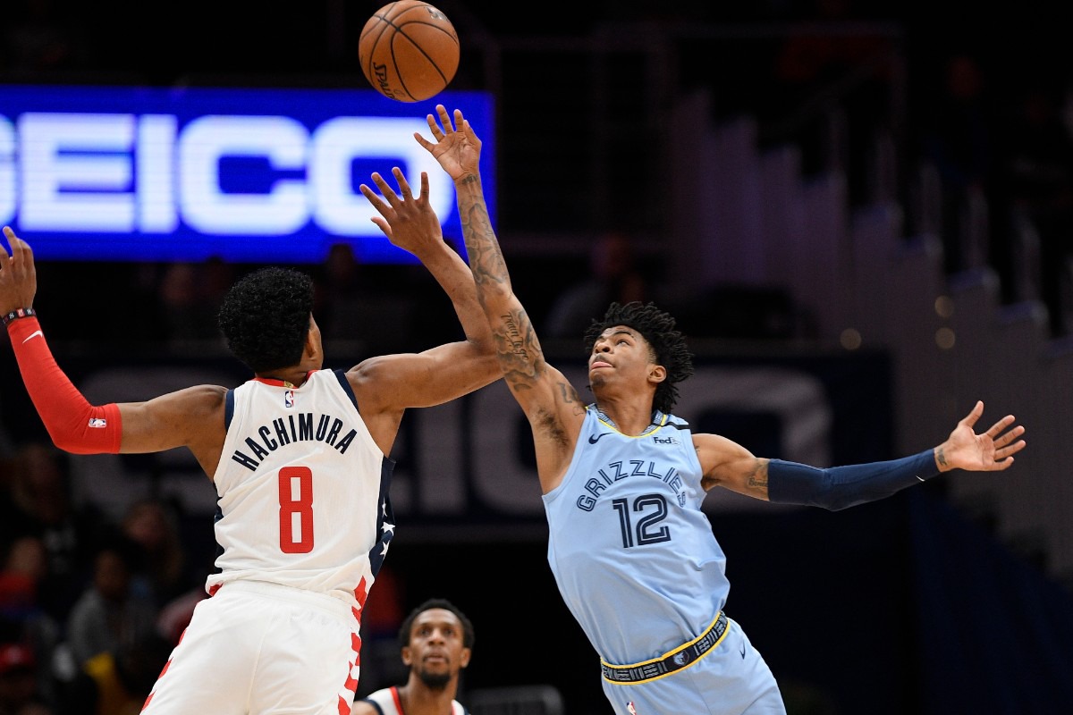 <strong>Memphis Grizzlies guard Ja Morant (12) and Washington Wizards forward Rui Hachimura (8) battle for the ball during the first half of an NBA game on Feb. 9, 2020, in Washington.</strong> (AP Photo/Nick Wass)