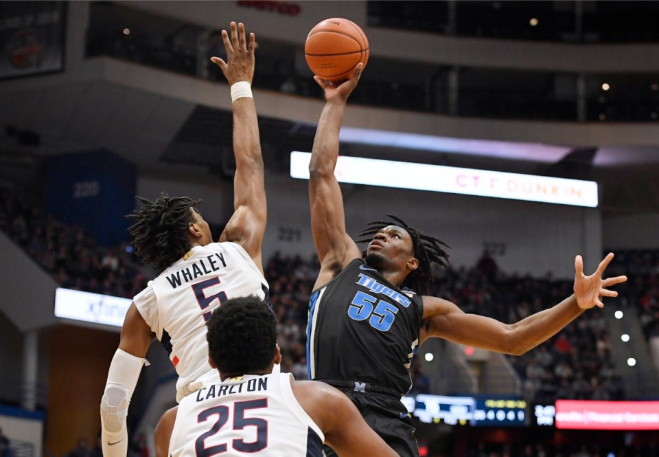 <strong>Memphis' Precious Achiuwa (55) shoots over Connecticut's Isaiah Whaley (5) as Connecticut's Josh Carlton (25) defends during an NCAA college basketball game Sunday, Feb. 16, 2020, in Hartford, Conn.</strong> (Jessica Hill/AP)