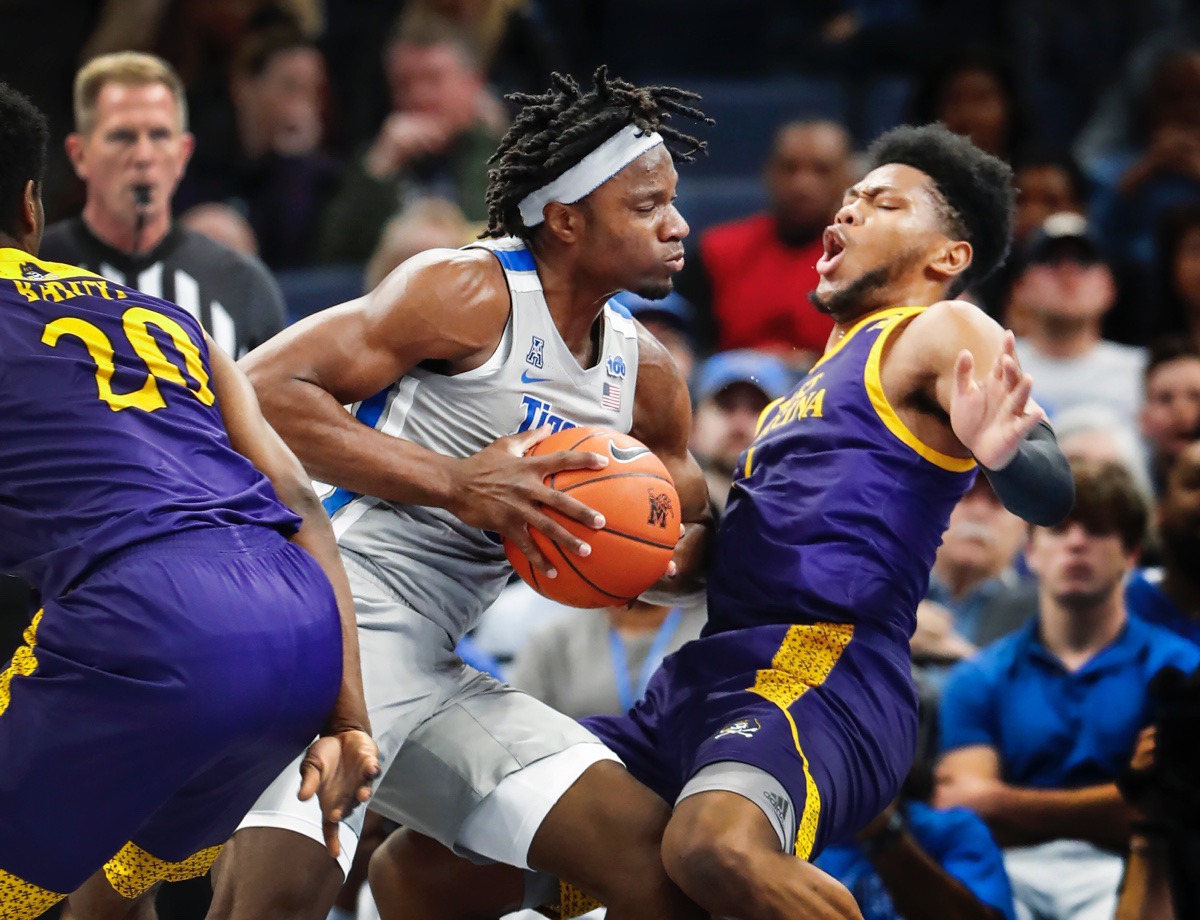 <strong>Memphis forward Precious Achiuwa (left) is called for a charging foul while driving the lane against ECU Feb. 19, 2020, at FedExForum.</strong> (Mark Weber/Daily Memphian)