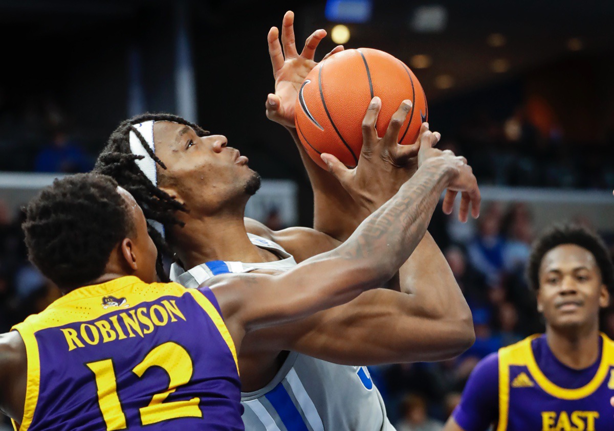 <strong>Memphis forward Precious Achiuwa (middle) is fouled by ECU defender Tremont Robinson-White (left) Feb. 19, 2020 at FedExForum.</strong> (Mark Weber/Daily Memphian)