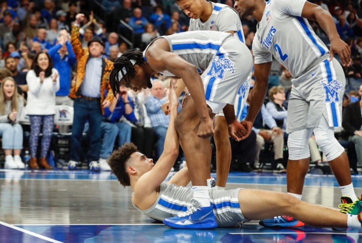 <strong>Memphis guard Lester Quinones (bottom) is helpedf up after scoring, and getting fouled in the bargain, against ECU Feb. 19, 2020, at FedExForum.</strong> (Mark Weber/Daily Memphian)