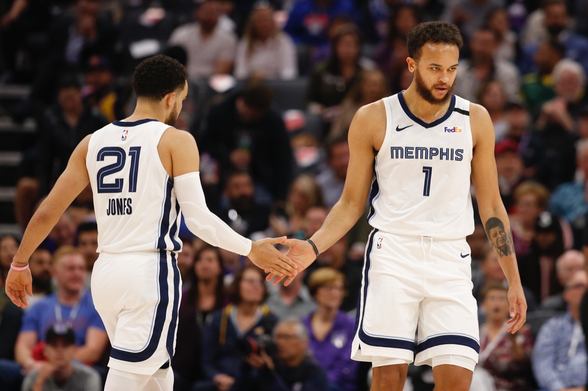 <strong>Tyus Jones, left, slaps palms with Kyle Anderson, right, as Anderson goes to the free-throw line against Sacramento Feb. 20, 2020.</strong> (Rich Pedroncelli/AP)