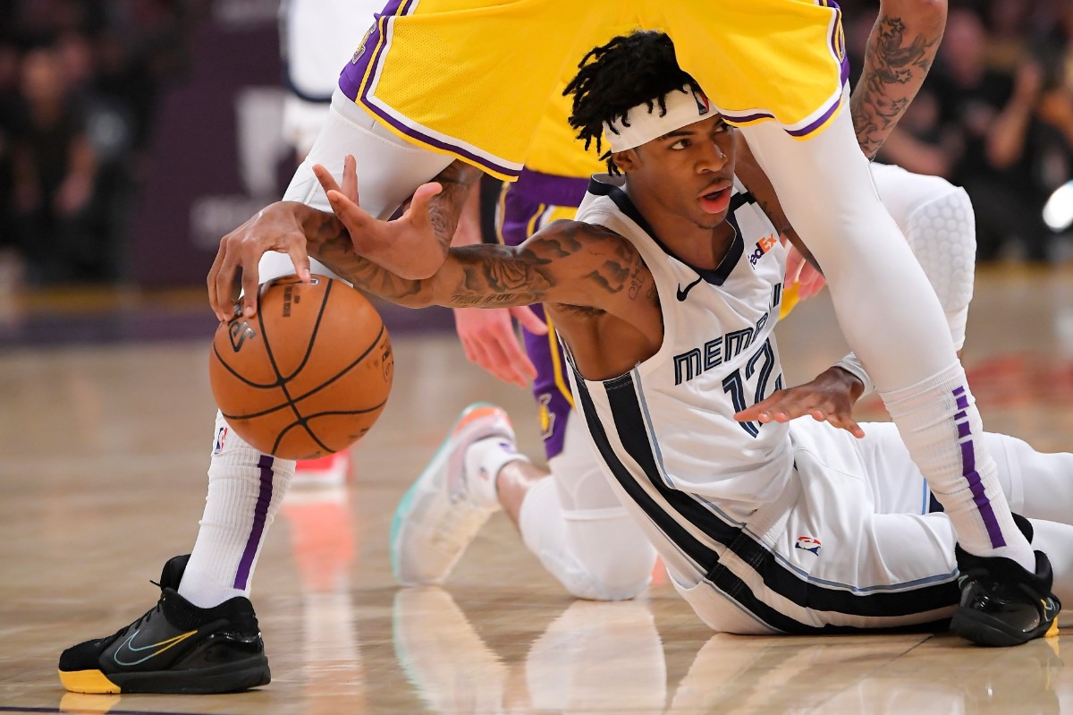 <strong>Memphis Grizzlies guard Ja Morant, below, tries to pass the ball from under the legs of Los Angeles Lakers forward Anthony Davis during the first half of an NBA basketball game Friday, Feb. 21, 2020, in Los Angeles.</strong> (Mark J. Terrill/AP)