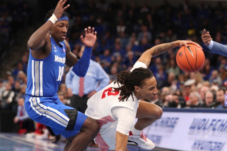 <strong>Houston guard Caleb Mills (2) gets tripped up on the court as Memphis guard Damion Baugh (10) defends in the first half&nbsp;of the Tigers game against Houston on Feb. 22, 2020, in Memphis.</strong> (AP Photo/Karen Pulfer Focht)