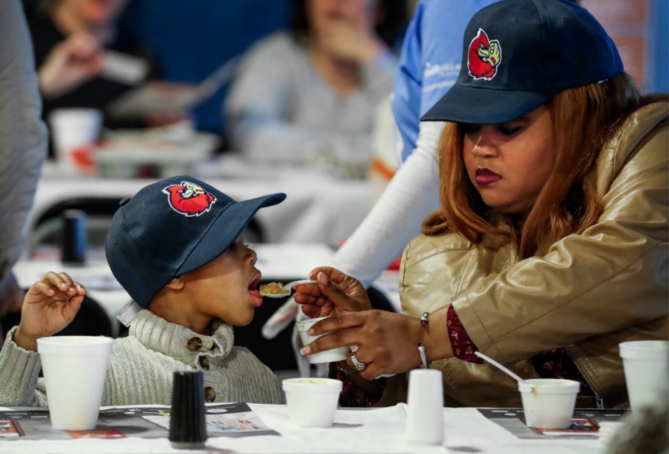 <strong>Nicole Johnson shares some of her soup with her son Noah, 4, during the Soup Sunday fundraiser Feb. 23, 2020 at FedExForum.</strong> (Mark Weber/Daily Memphian)